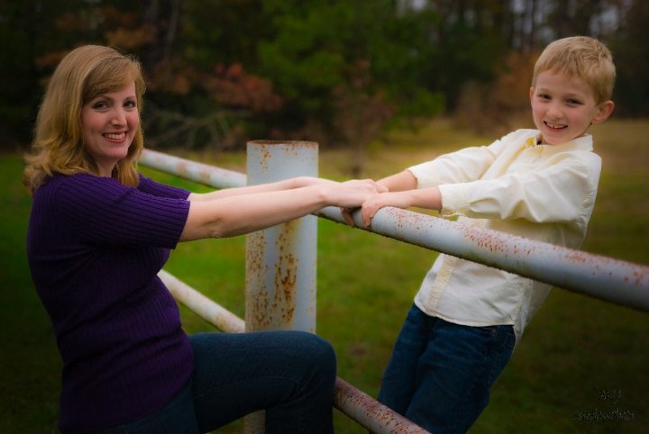 mother and son on fence